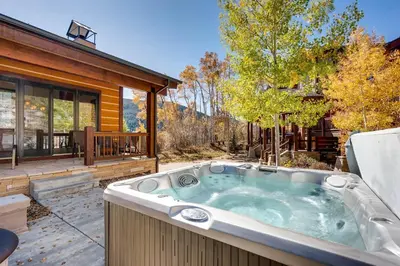 a hot tub in a yard next to a house at Sanctuary 2569 in Keystone