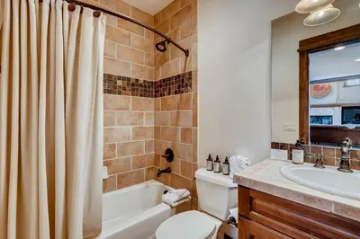 a bathroom with a tub and a toilet and a sink at Sanctuary 2569 in Keystone