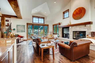 a living room with a couch and a fireplace at Sanctuary 2569 in Keystone