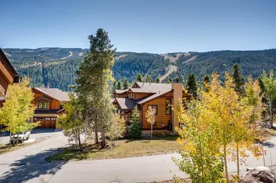 an image of a log home with mountains in the background at Sanctuary 2569 in Keystone