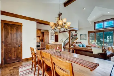 a kitchen and dining room with a wooden table and chairs at Sanctuary 2569 in Keystone