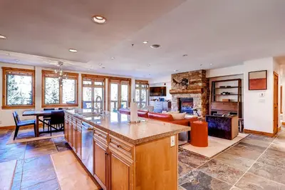 a kitchen and living room with a table and a couch at Timbers 3077 in Keystone