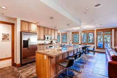 a kitchen with a large island with bar stools at Timbers 3077 in Keystone