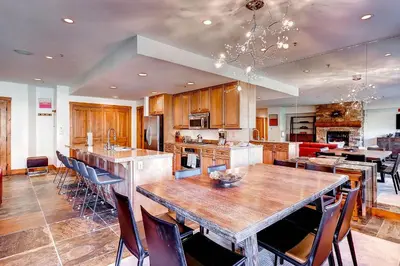 a large kitchen with a large wooden table and chairs at Timbers 3077 in Keystone
