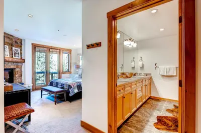 a bathroom with a sink and a bed in a room at Timbers 3077 in Keystone