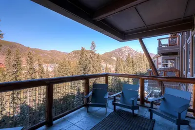 a balcony with chairs and a view of mountains at Timbers 3077 in Keystone