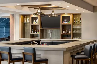 a bar with chairs and a flat screen tv at Hyatt Place Keystone - Dillon in Keystone