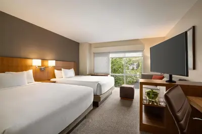 a hotel room with two beds and a flat screen tv at Hyatt Place Keystone - Dillon in Keystone