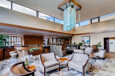 a large lobby with chairs and a bar at Keystone Lodge & Spa, A Vail Resorts Property in Keystone