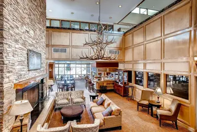 a large living room with a couch and a fireplace at Keystone Lodge & Spa, A Vail Resorts Property in Keystone