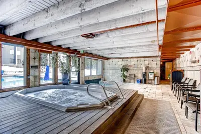 a large room with a hot tub on a wooden deck at Keystone Lodge & Spa, A Vail Resorts Property in Keystone