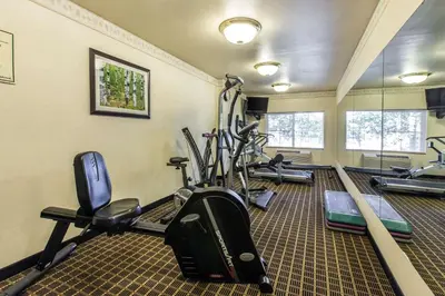 a gym with several treadmills and elliptical machines at Quality Inn and Suites Silverthorne - Copper Mountain in Silverthorne