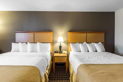 a hotel room with two beds and a lamp at Quality Inn and Suites Silverthorne - Copper Mountain in Silverthorne