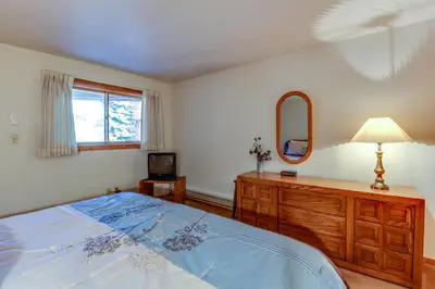 a bedroom with a bed and a dresser and a mirror at Lakeview Marina Place in Dillon