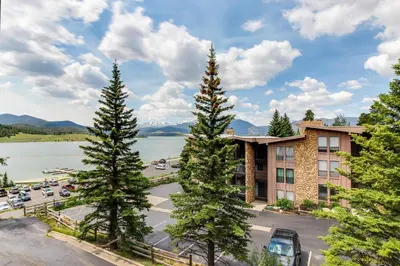 a hotel with trees in front of a parking lot at Lakeview Marina Place in Dillon