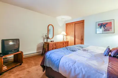 a bedroom with a large bed and a tv at Lakeview Marina Place in Dillon