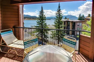 a balcony with chairs and a table and a view of a lake at Lakeview Marina Place in Dillon