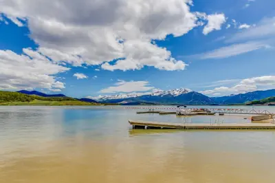 a dock on a lake with mountains in the background at Lakeview Marina Place in Dillon