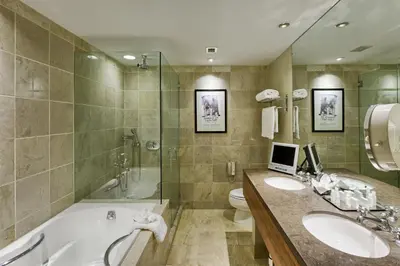 a bathroom with a tub and a sink and a toilet at Hotel Teatro in Denver