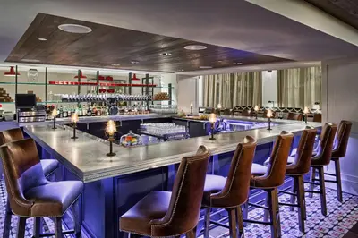 a bar with a row of chairs at a restaurant at Hotel Teatro in Denver