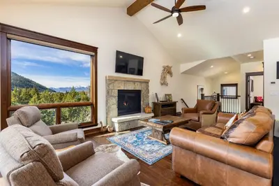 a living room with a fireplace and a large window at 47B River Run Townhomes in Keystone
