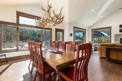 a dining room with a wooden table and chairs at 47B River Run Townhomes in Keystone
