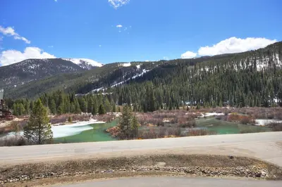 a view of a river with mountains in the background at 47B River Run Townhomes in Keystone