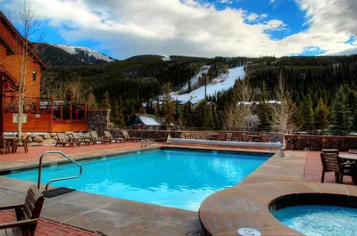 a swimming pool with a mountain in the background at 47B River Run Townhomes in Keystone
