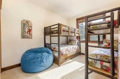 a bedroom with bunk beds and a blue bean bag at 47B River Run Townhomes in Keystone