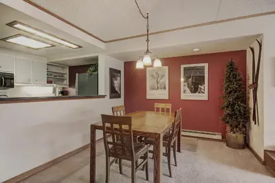 a kitchen and dining room with a table and chairs at 2092 The Pines Condo in Keystone