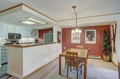 a kitchen and dining room with a table and chairs at 2092 The Pines Condo in Keystone