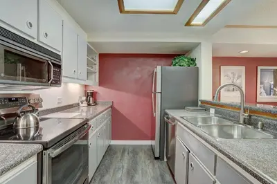 a kitchen with a sink and a refrigerator at 2092 The Pines Condo in Keystone