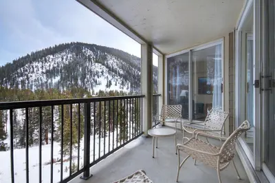 a balcony with chairs and a view of a mountain at 2092 The Pines Condo in Keystone