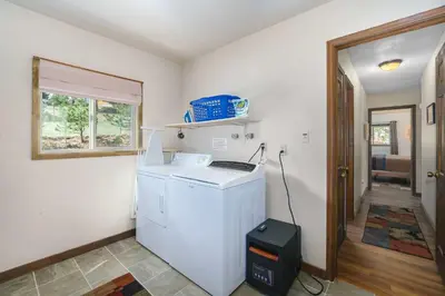 a kitchen with a white refrigerator and a window at Sky View in the Rockies in Estes Park