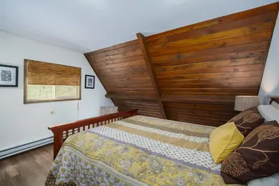 a bedroom with a bed and a wooden headboard at Sky View in the Rockies in Estes Park