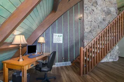 an attic room with a desk with a computer on it at Sky View in the Rockies in Estes Park