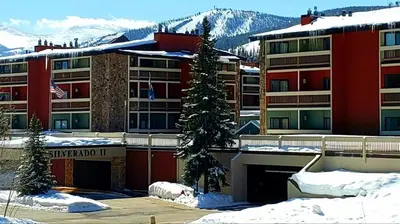 a hotel with a christmas tree in the snow at Silverado II in Winter Park