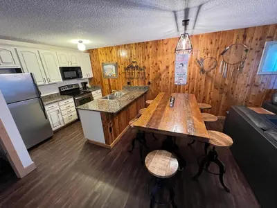 a kitchen with a wooden table and a refrigerator at Silverado II in Winter Park