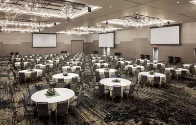 a large room with white tables and chairs at Doubletree By Hilton Greeley At Lincoln Park in Greeley
