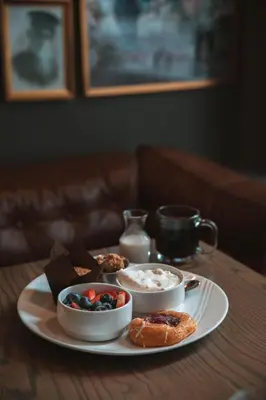 a table with a plate of food on a table at Magnolia Hotel Denver, a Tribute Portfolio Hotel in Denver