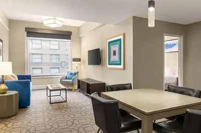 a living room with a table and chairs at Magnolia Hotel Denver, a Tribute Portfolio Hotel in Denver