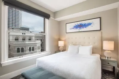 a bedroom with a bed and a large window at Magnolia Hotel Denver, a Tribute Portfolio Hotel in Denver