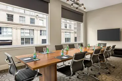 a conference room with a large table and chairs at Magnolia Hotel Denver, a Tribute Portfolio Hotel in Denver