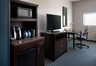 a hotel room with a desk with a television and a computer at Hilton Garden Inn Denver/Cherry Creek in Denver