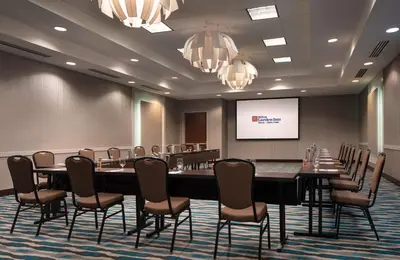 a conference room with a long table and chairs at Hilton Garden Inn Denver/Cherry Creek in Denver