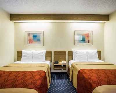 a hotel room with two beds in it at Econo Lodge Denver International Airport in Aurora