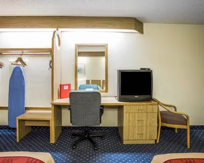 a room with a desk with a tv and a desk sidx sidx sidx at Econo Lodge Denver International Airport in Aurora