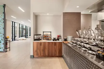 a large kitchen with a counter in a restaurant at Hilton Garden Inn Boulder in Boulder