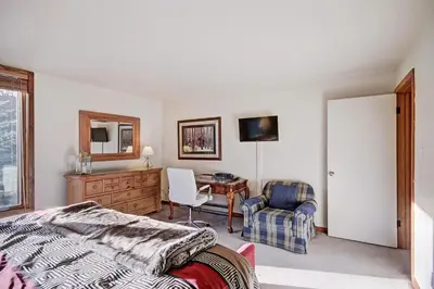 a bedroom with a bed and a desk and a chair at 2019 Lodgepole Condo in Keystone