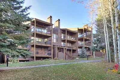 a large building with trees in front of it at 2019 Lodgepole Condo in Keystone